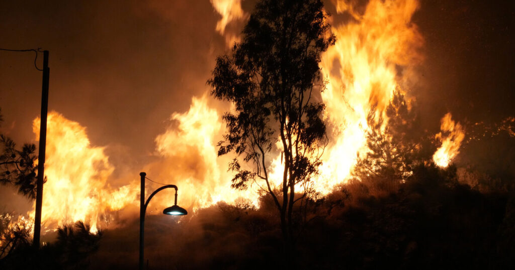 Firefighters battle wildfire burning out of control on Greek island