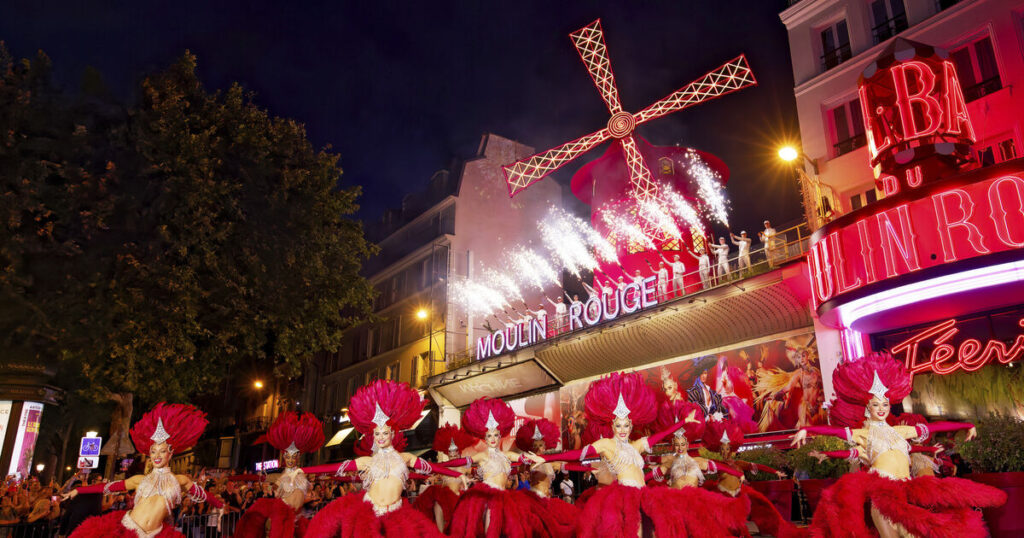 Moulin Rouge’s windmill sails turn again after restoration